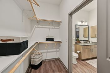 A bathroom with a toilet, sink, and mirror.